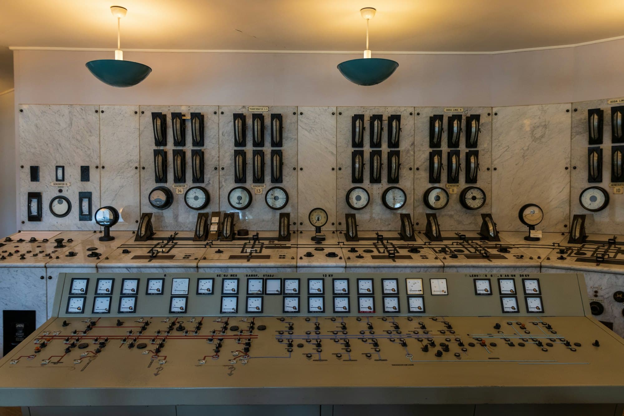 A wall of dials and switches in an industrial control room
