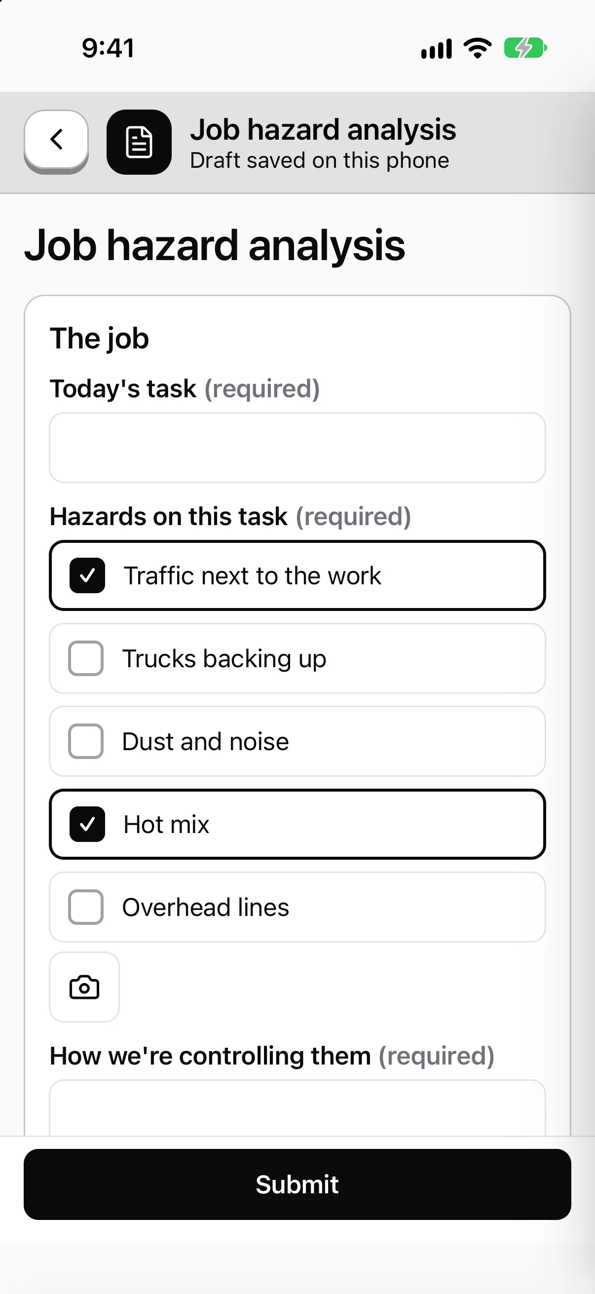 The Job hazard analysis form on the phone: a task box and a hazards checklist with Traffic next to the work and Hot mix ticked, a photo button, and a Submit button. The top says the draft is saved on this phone.